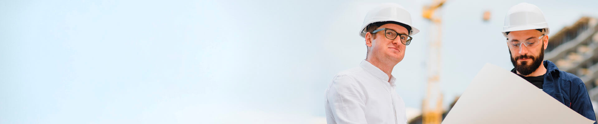 Dos ingenieros revisan los planos en el sitio de la obra.  Con el Crédito Constructor ya han iniciado el proyecto.